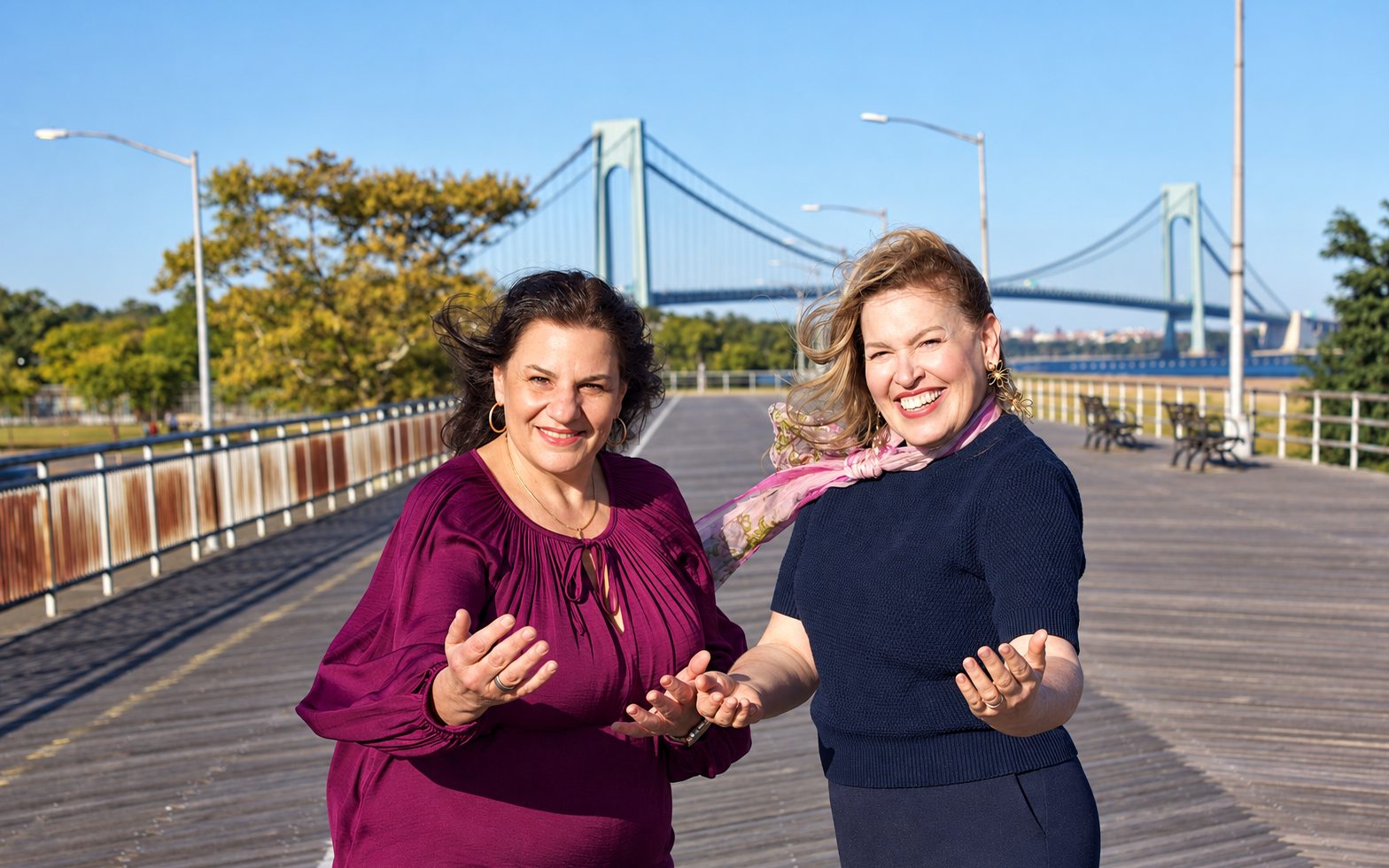 Mayra Sanchez and Christina on the boardwalk by the Verrazzano Bridge, welcoming with open hands