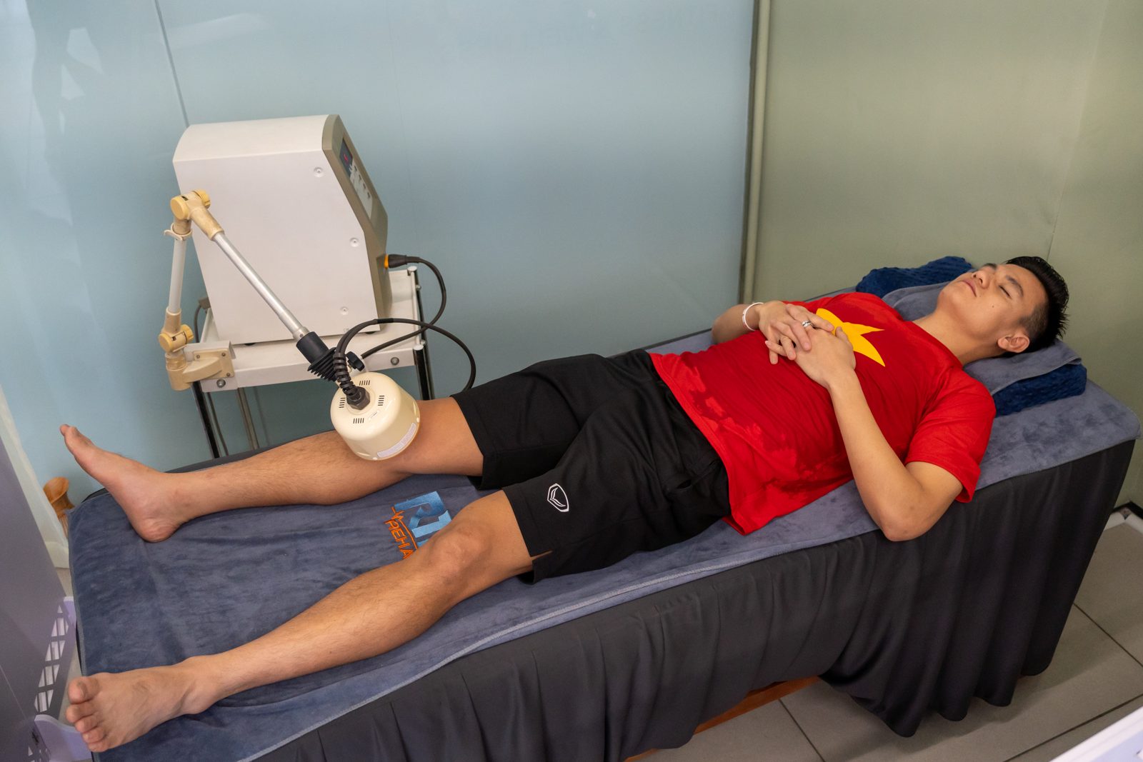 Chân duỗi thẳng trên giường trong buổi trị liệu gối
