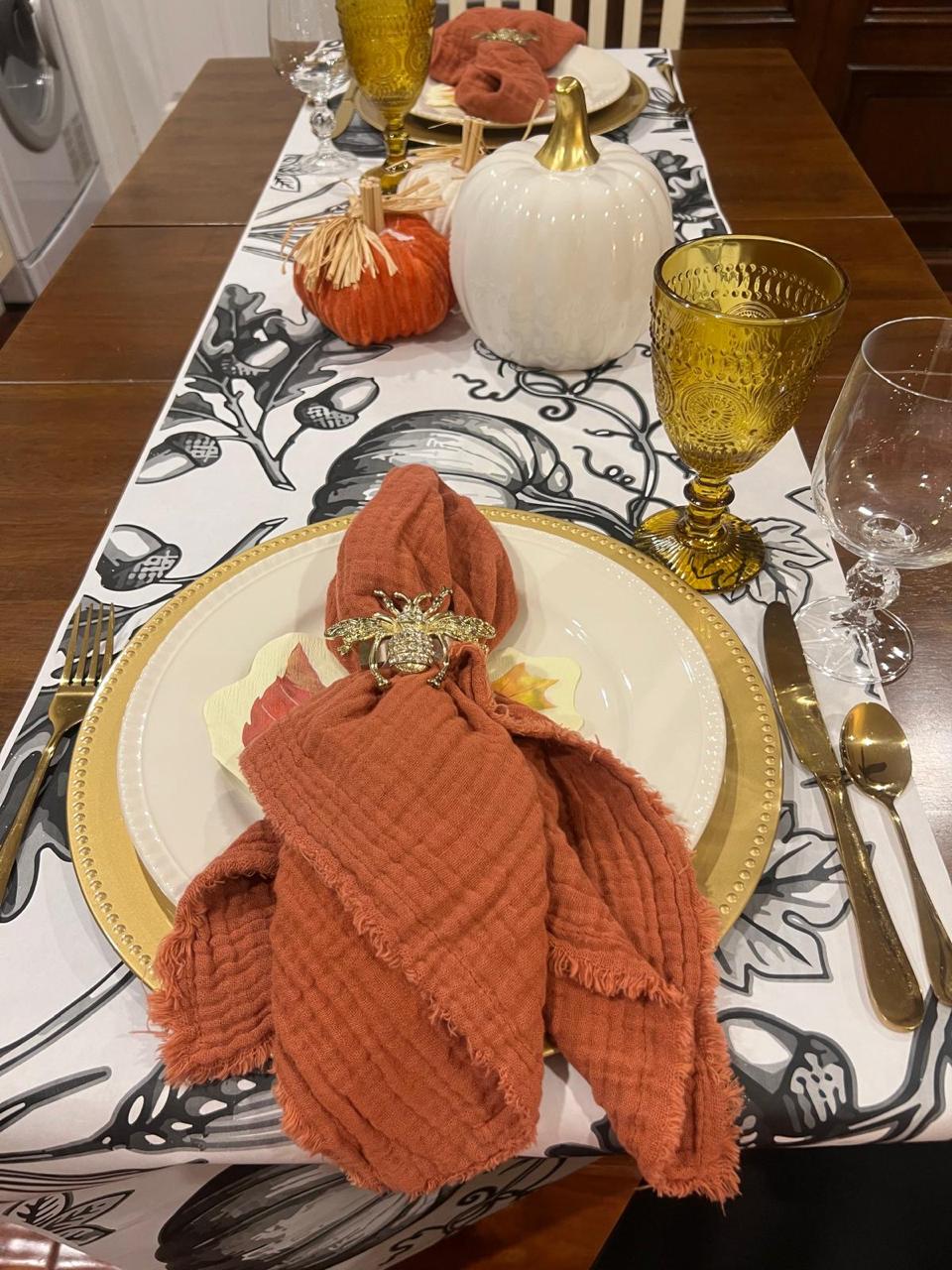 Neutral runner with candles running down the center of a Thanksgiving table Neutral runner with candles running down the center of a Thanksgiving table