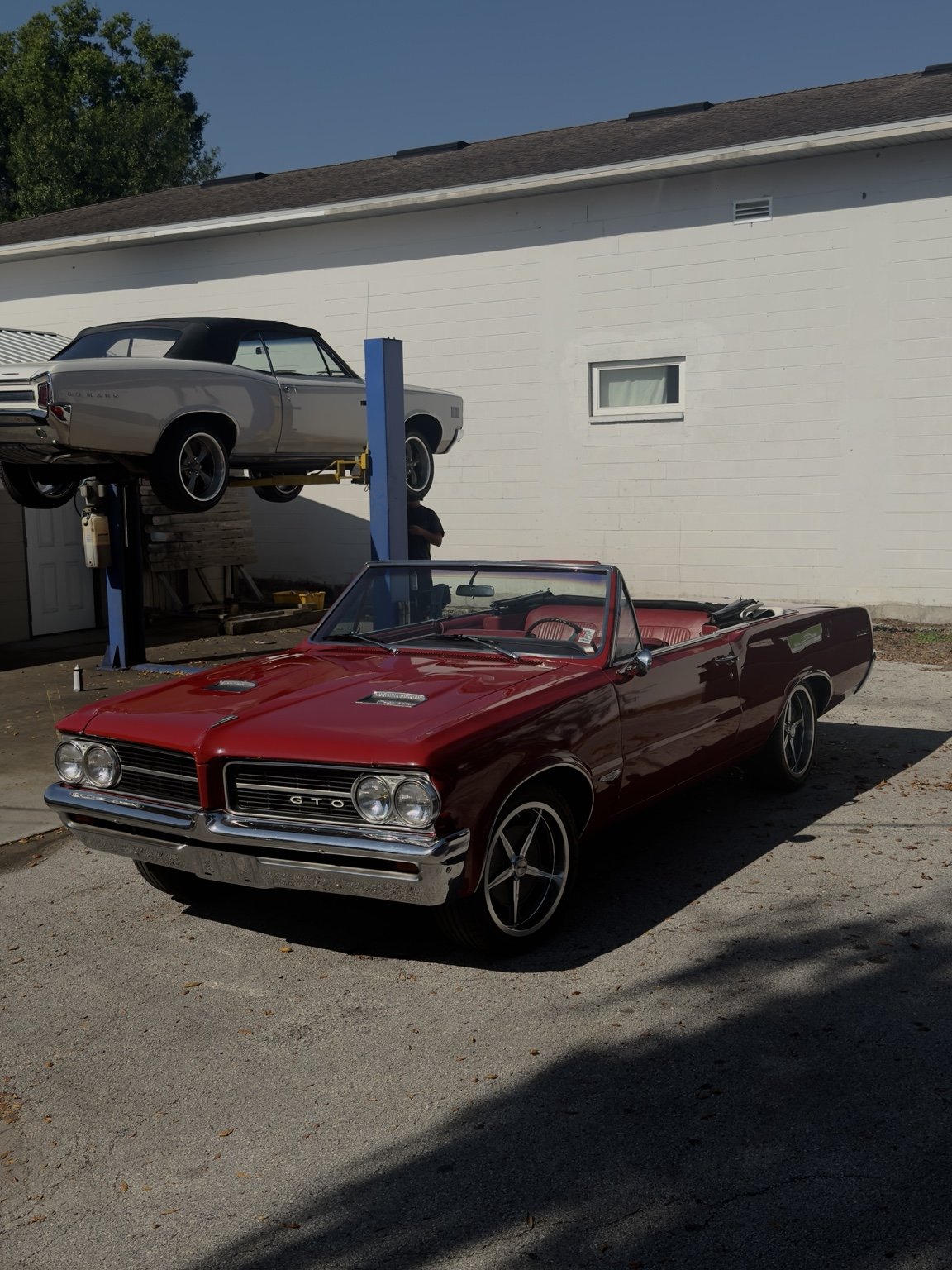 Red classic convertible at the detailing shop