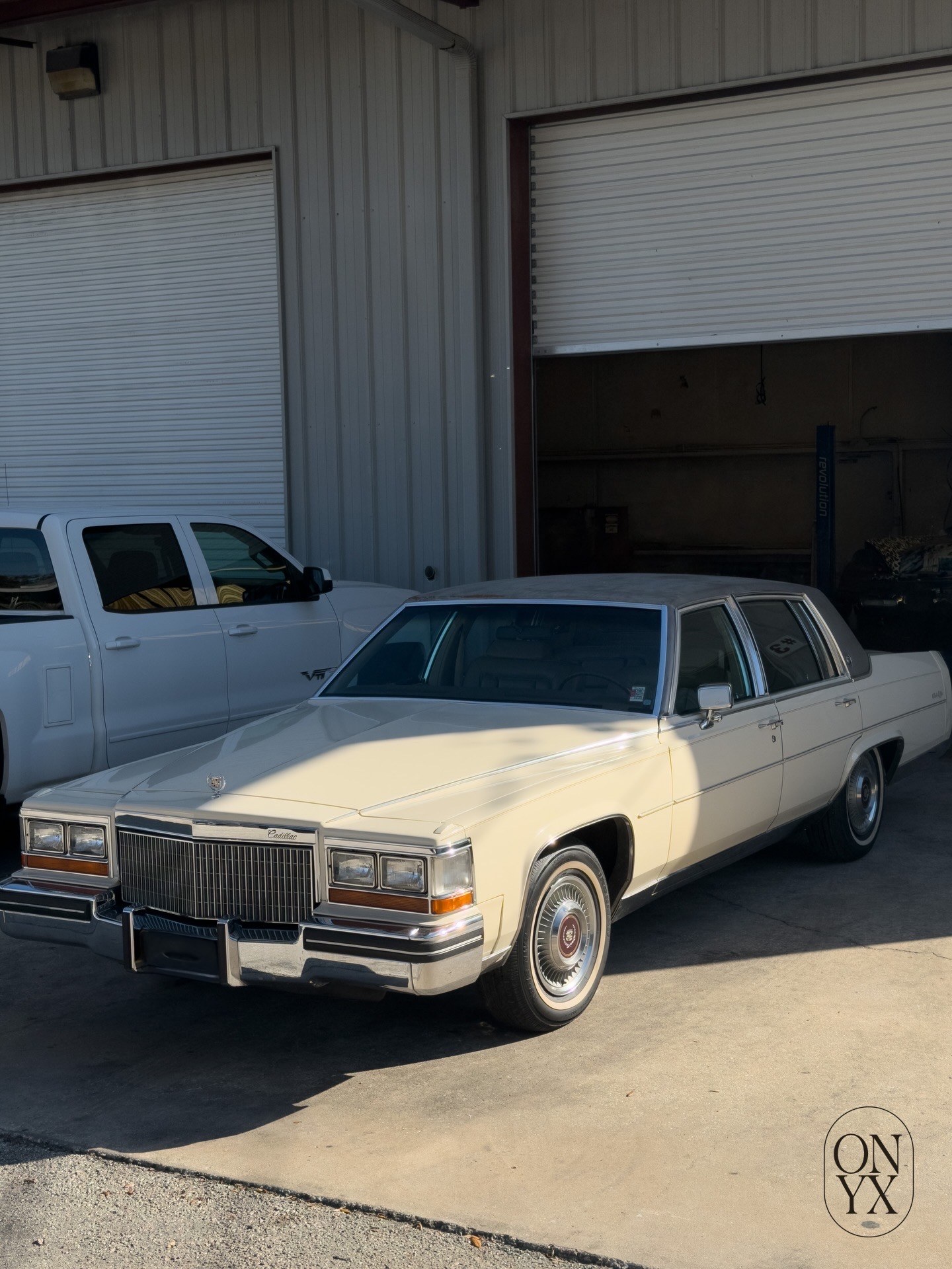 White classic Cadillac outside the detail shop