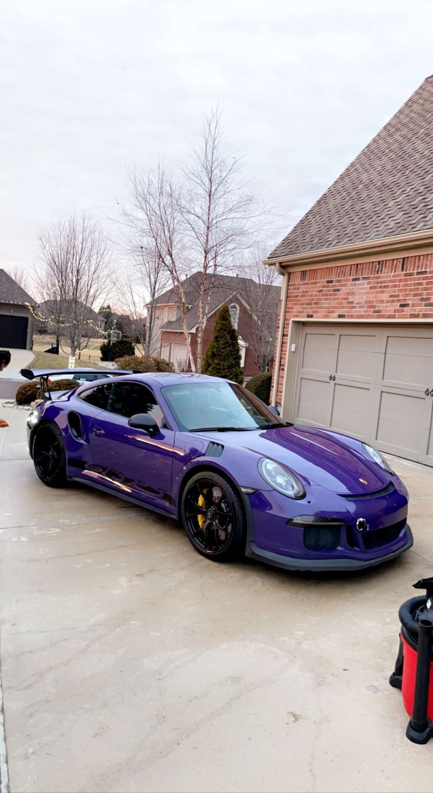 Purple Porsche 911 parked in a driveway