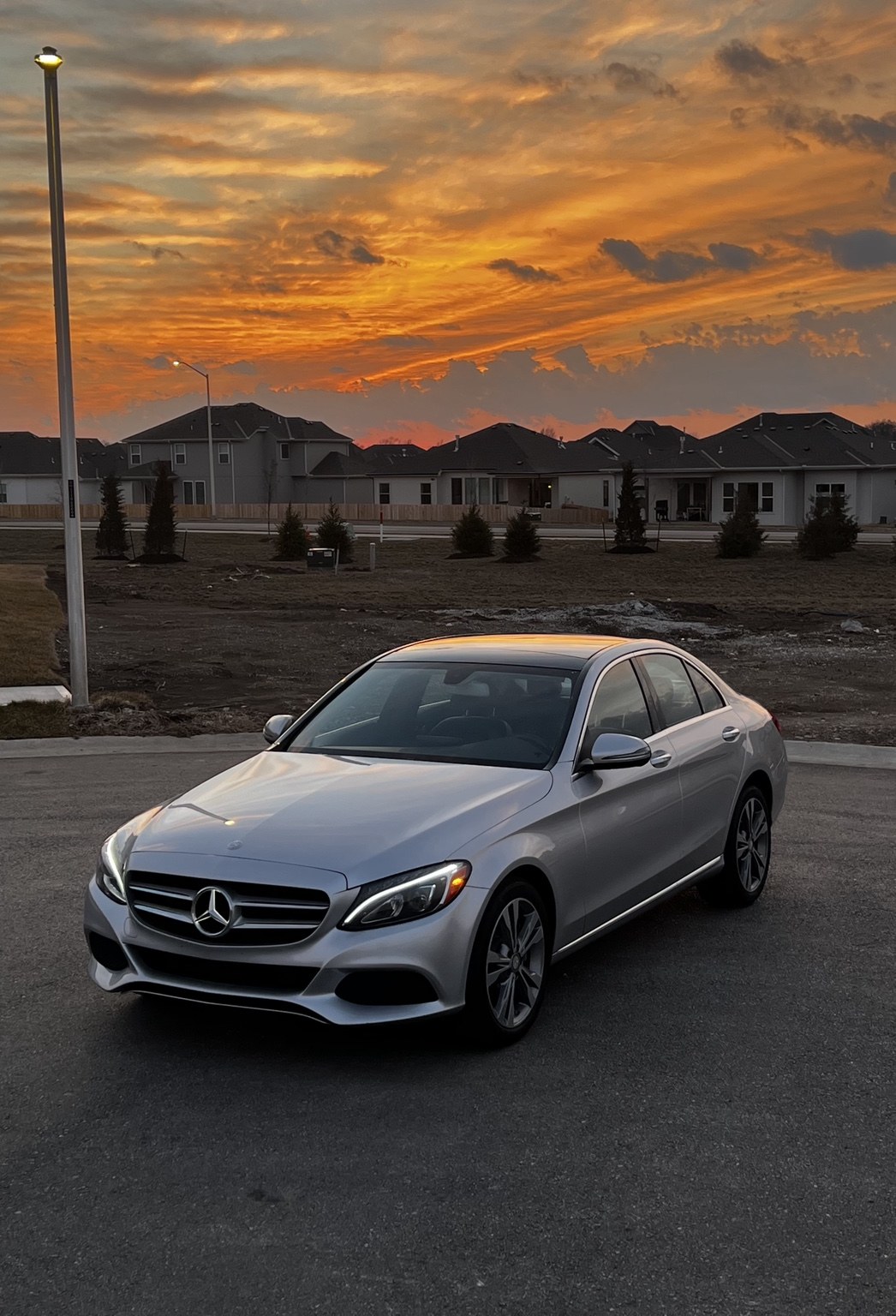 Silver Mercedes sedan at sunset