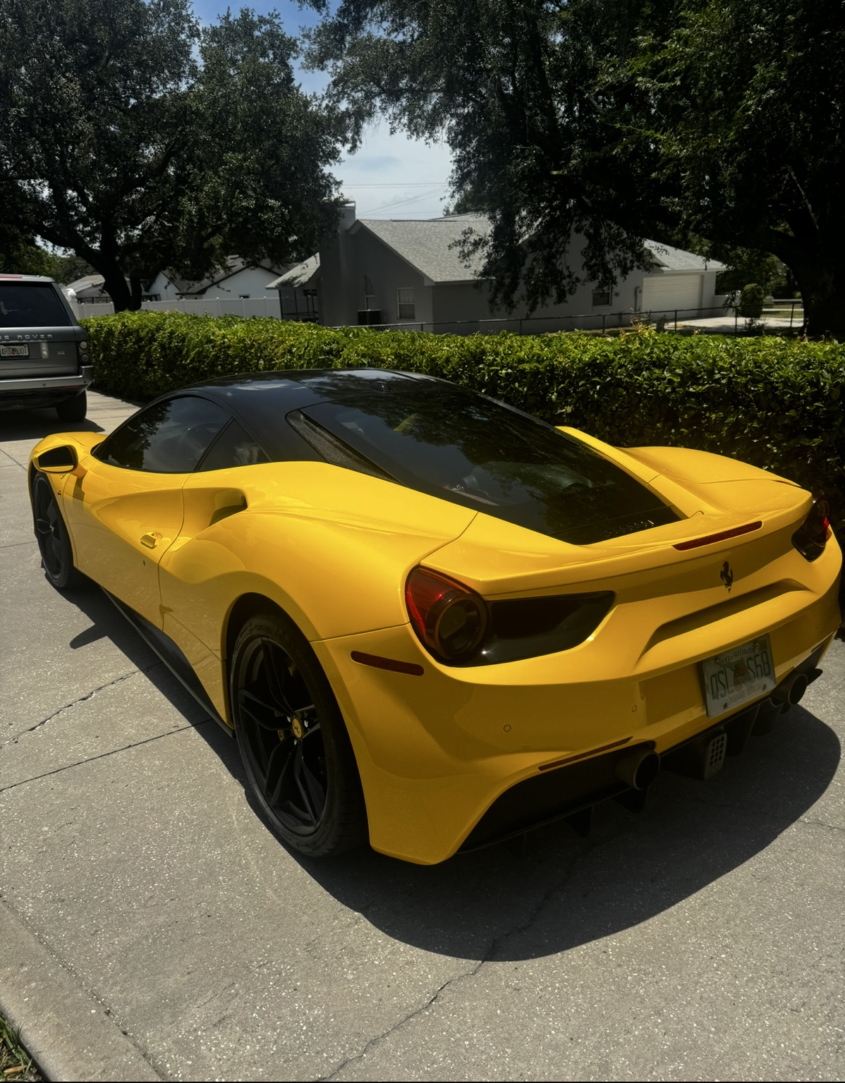 Yellow Ferrari parked at a residential detailing appointment