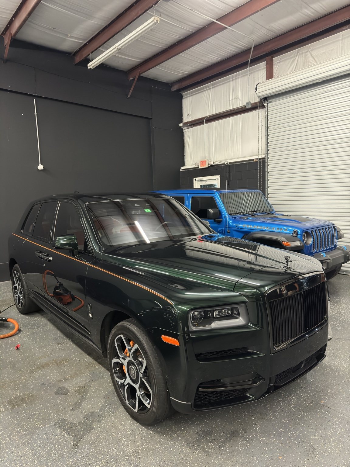 Black Rolls-Royce in the detail bay