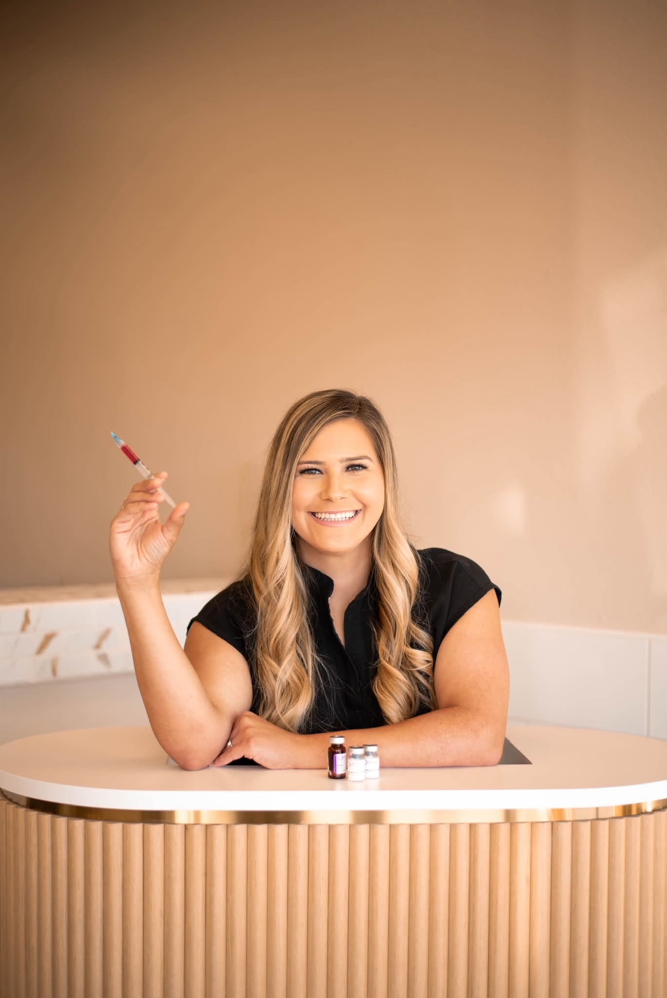 Jodi Peña, RN, at the front counter of Cove Aesthetics
