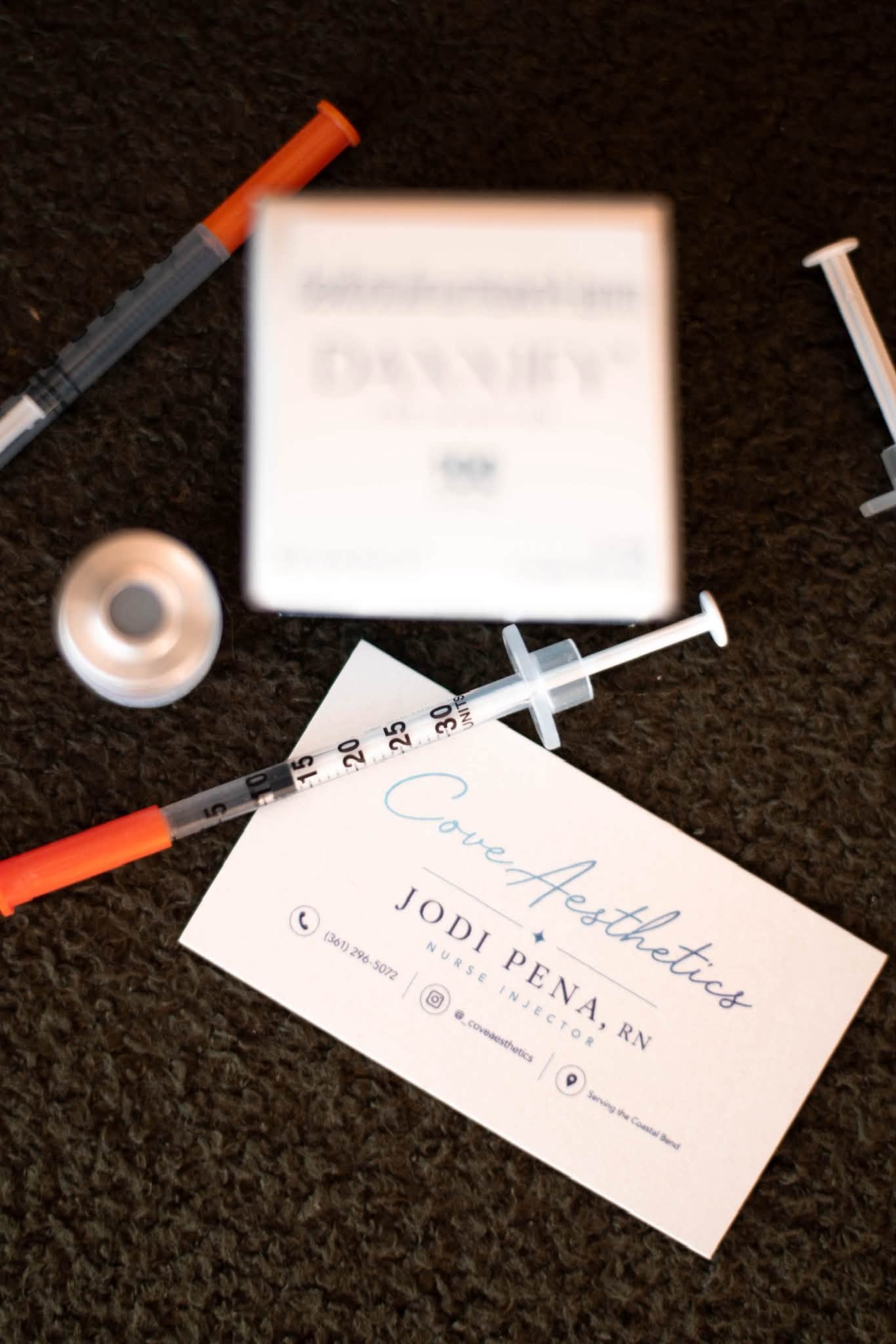 Cove Aesthetics business card, syringes and neurotoxin preparation
