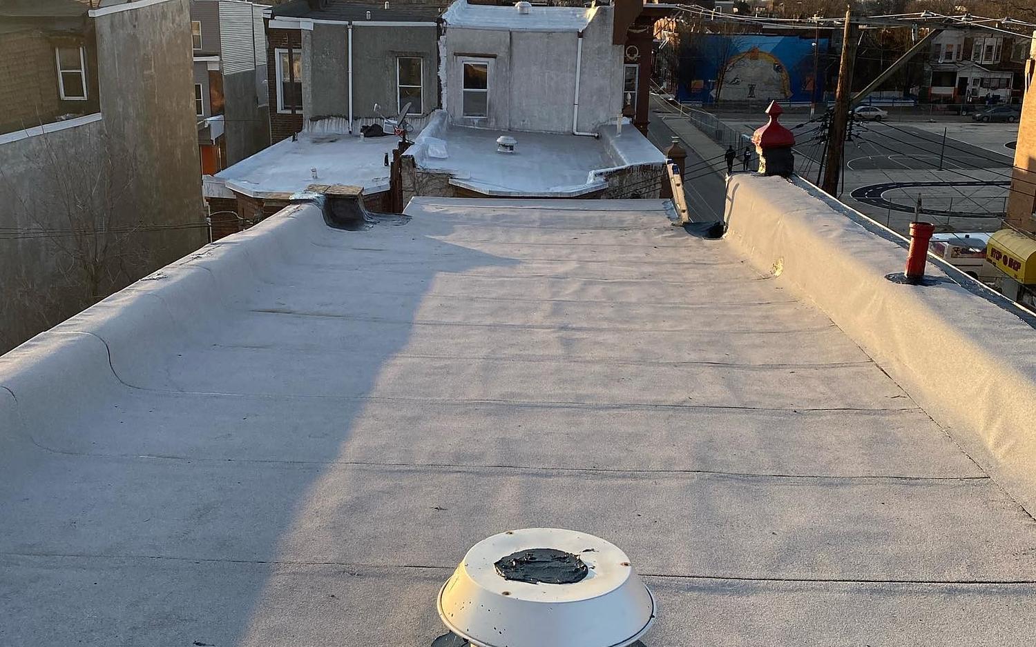 Completed flat roof replacement over Philadelphia at sunset