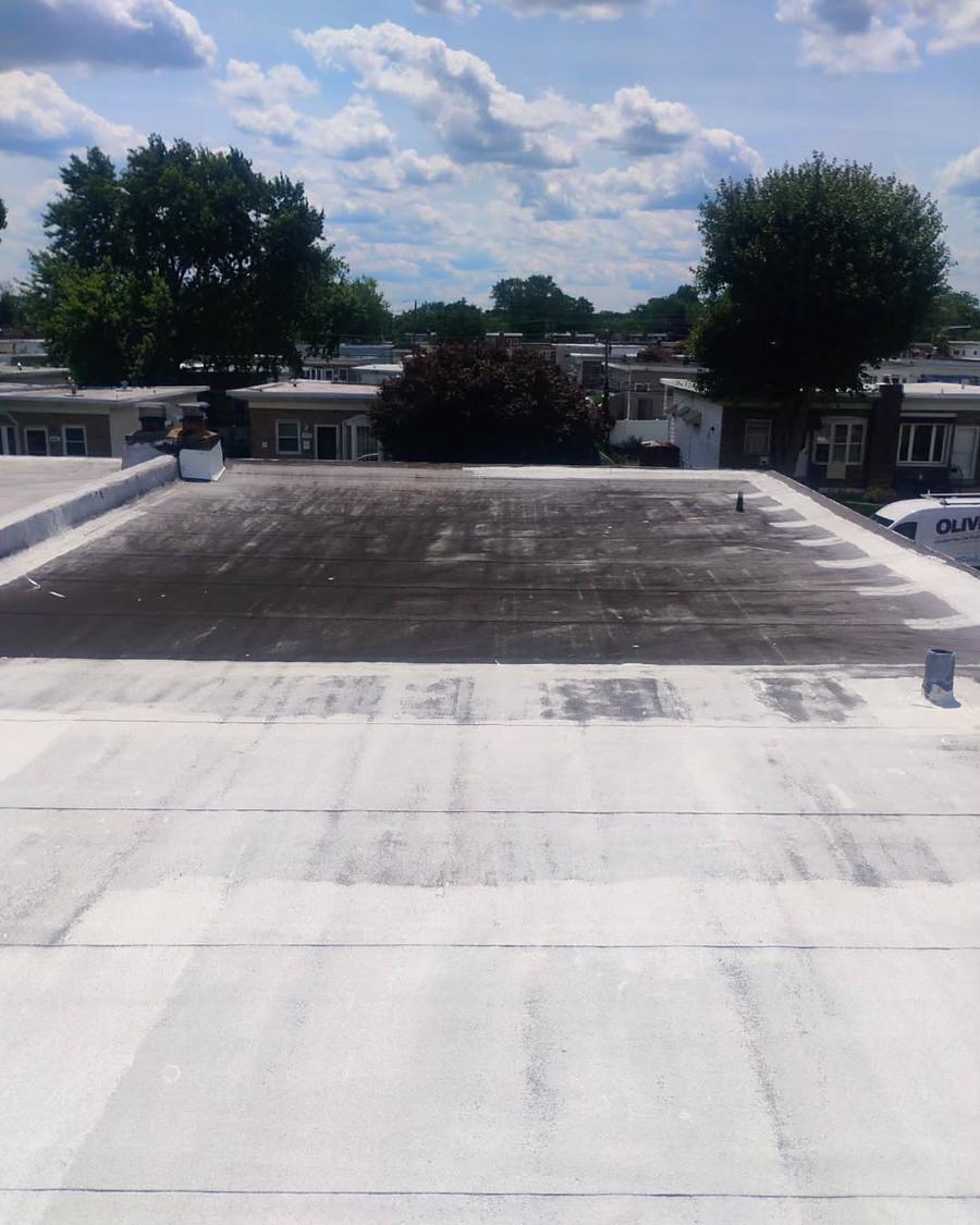 The other half of the same roof, old silver coating worn back to the asphalt