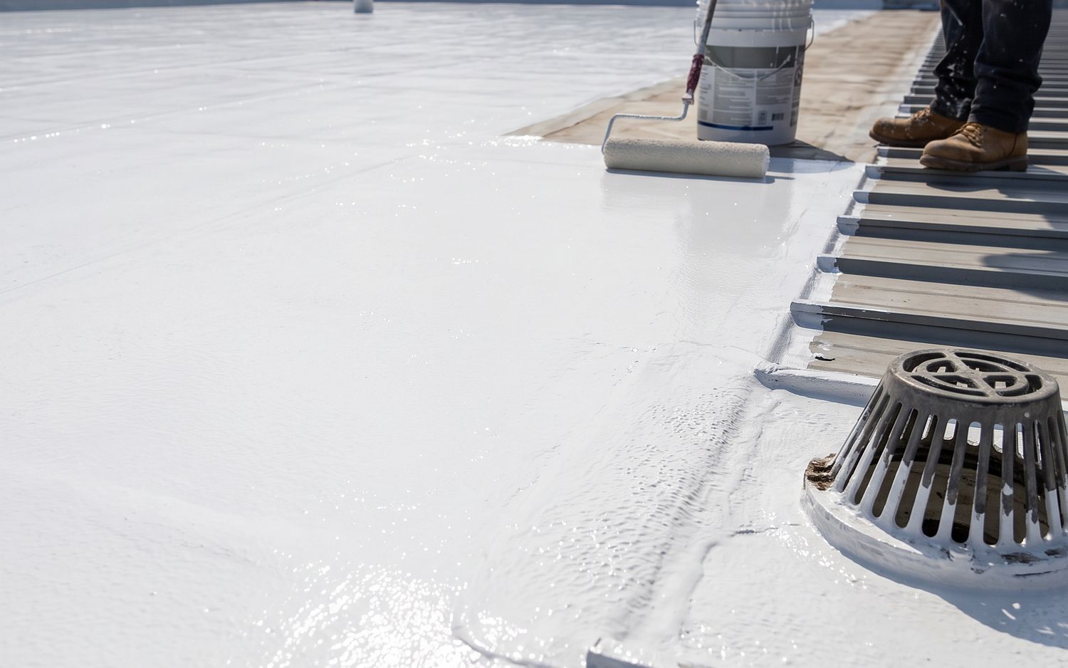 A seamless white silicone coating rolled over a low-slope roof