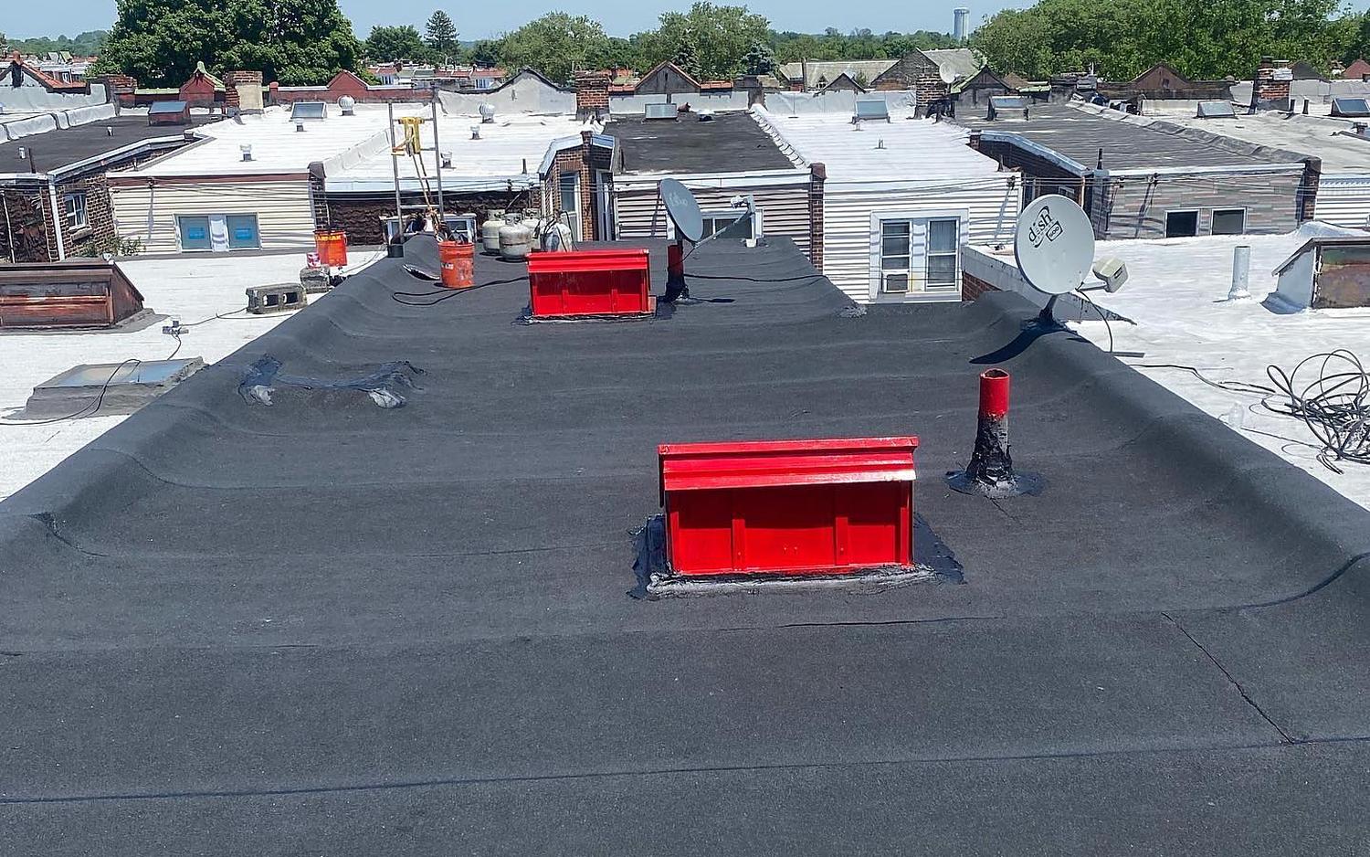 Completed flat roof replacement with new skylight curbs