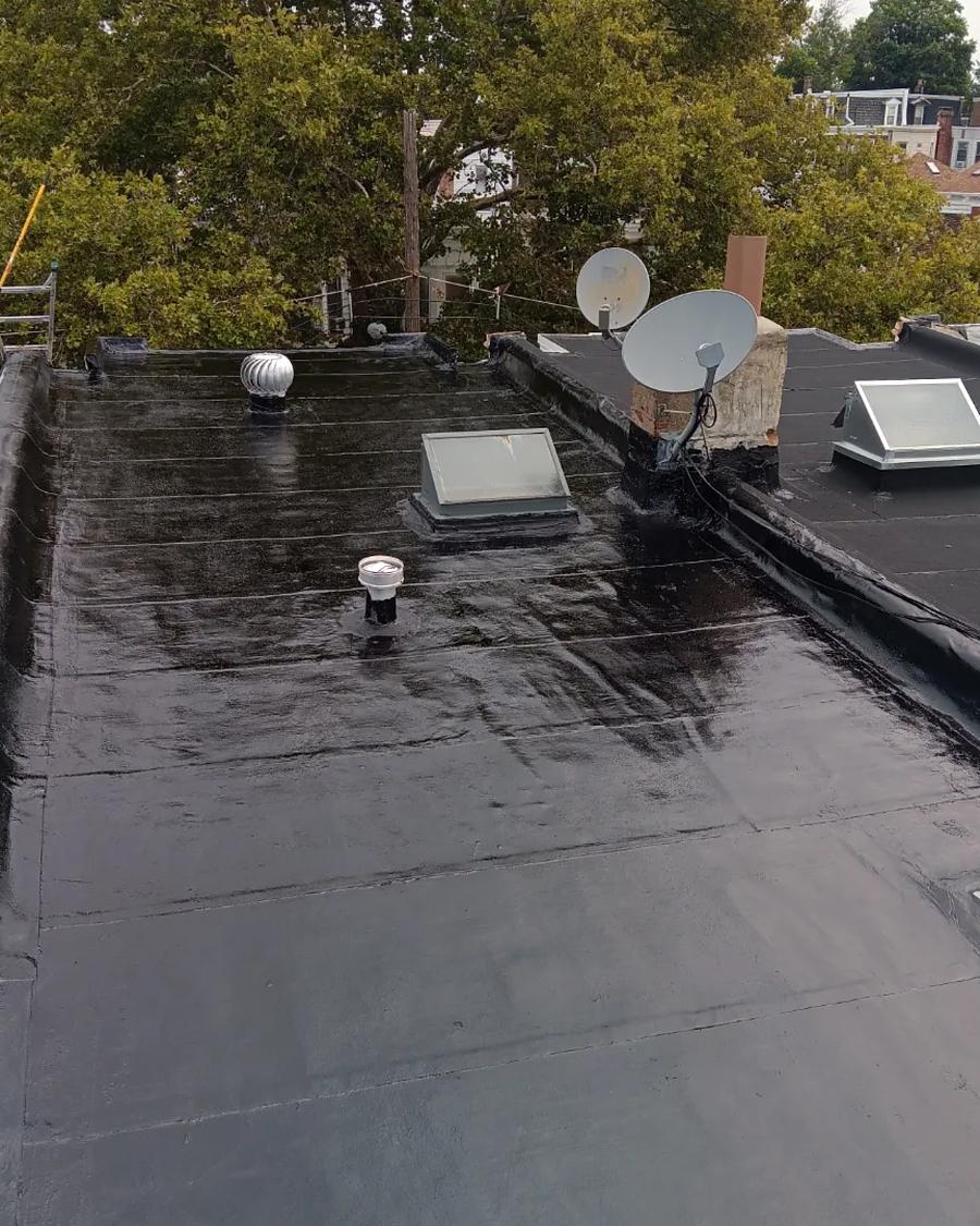 New rubber roof running the full length of a Philadelphia row home