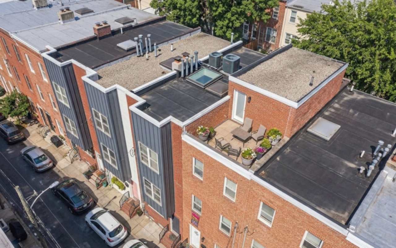 Flat-roofed brick rows with parapets and a roof deck, seen from above in the Philadelphia river wards