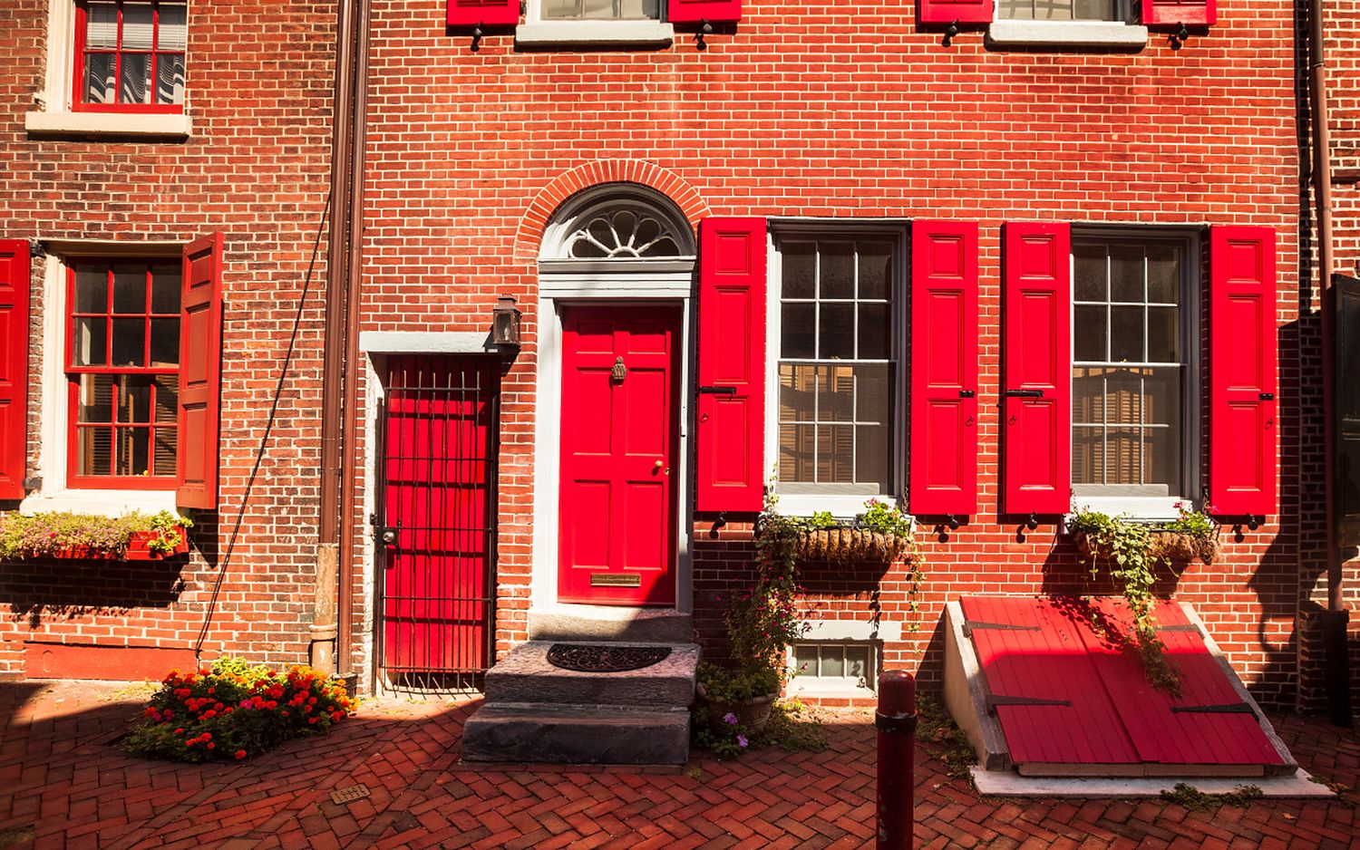 Windows and doors on a red brick Philadelphia row home