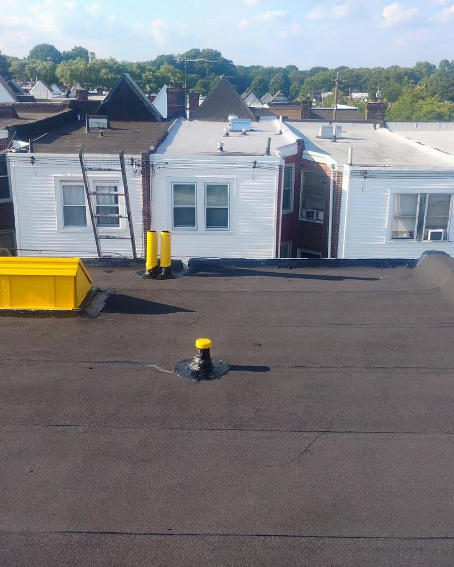 The same run finished in new membrane, job dumpster still on site