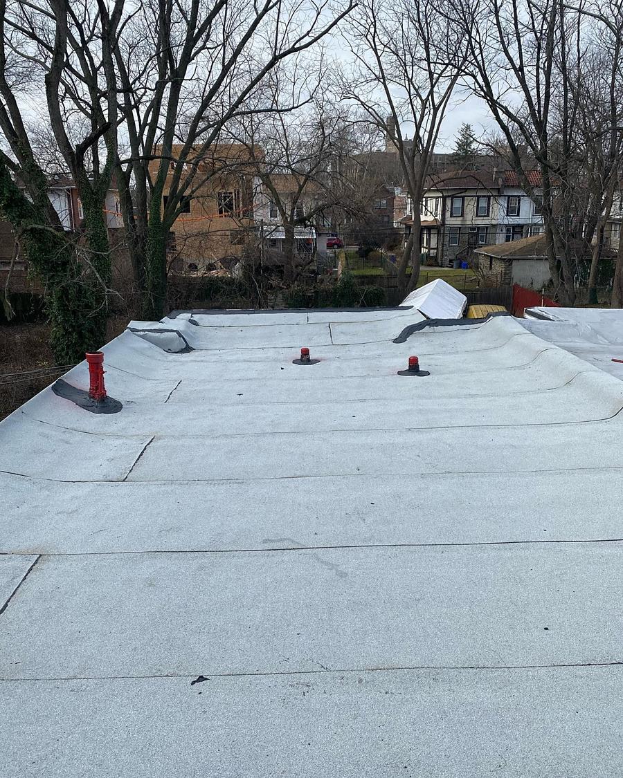 The completed roof, coated and sealed, new pipe boots in