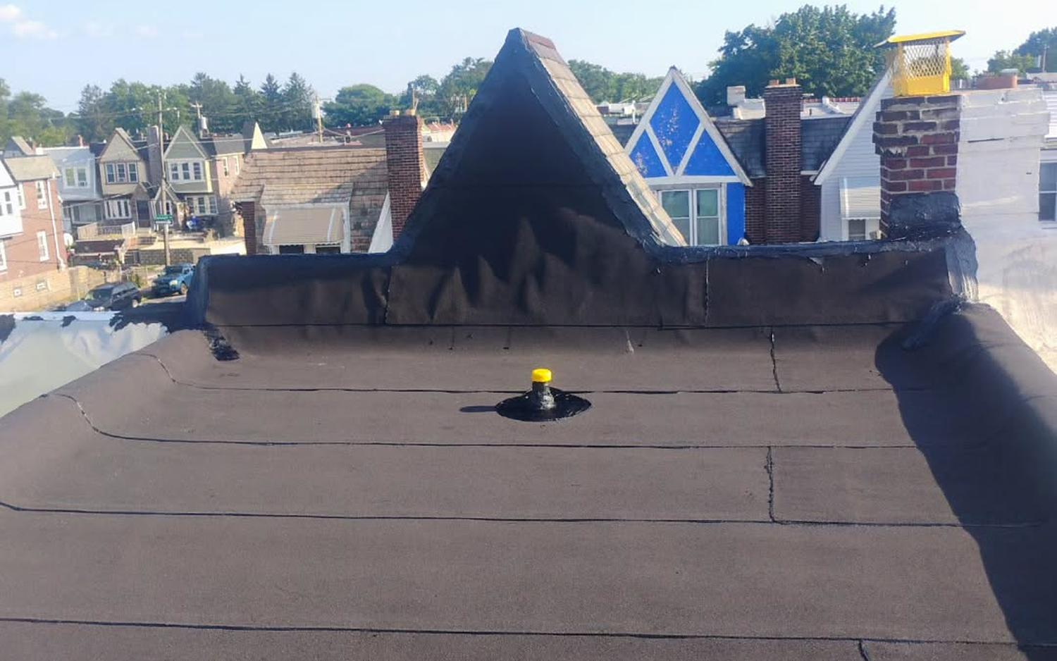 New flat roof membrane wrapped around a Philadelphia cone dormer