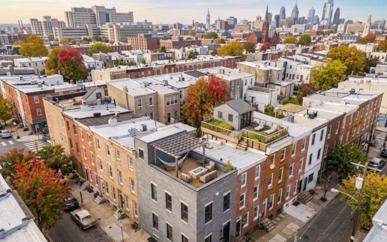Narrow South Philadelphia rows with flat roofs running toward the Center City skyline