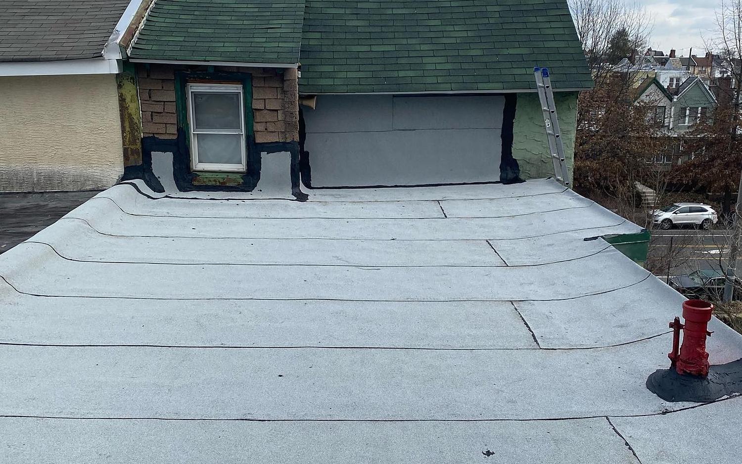 Finished white-coated flat roof on a Philadelphia twin