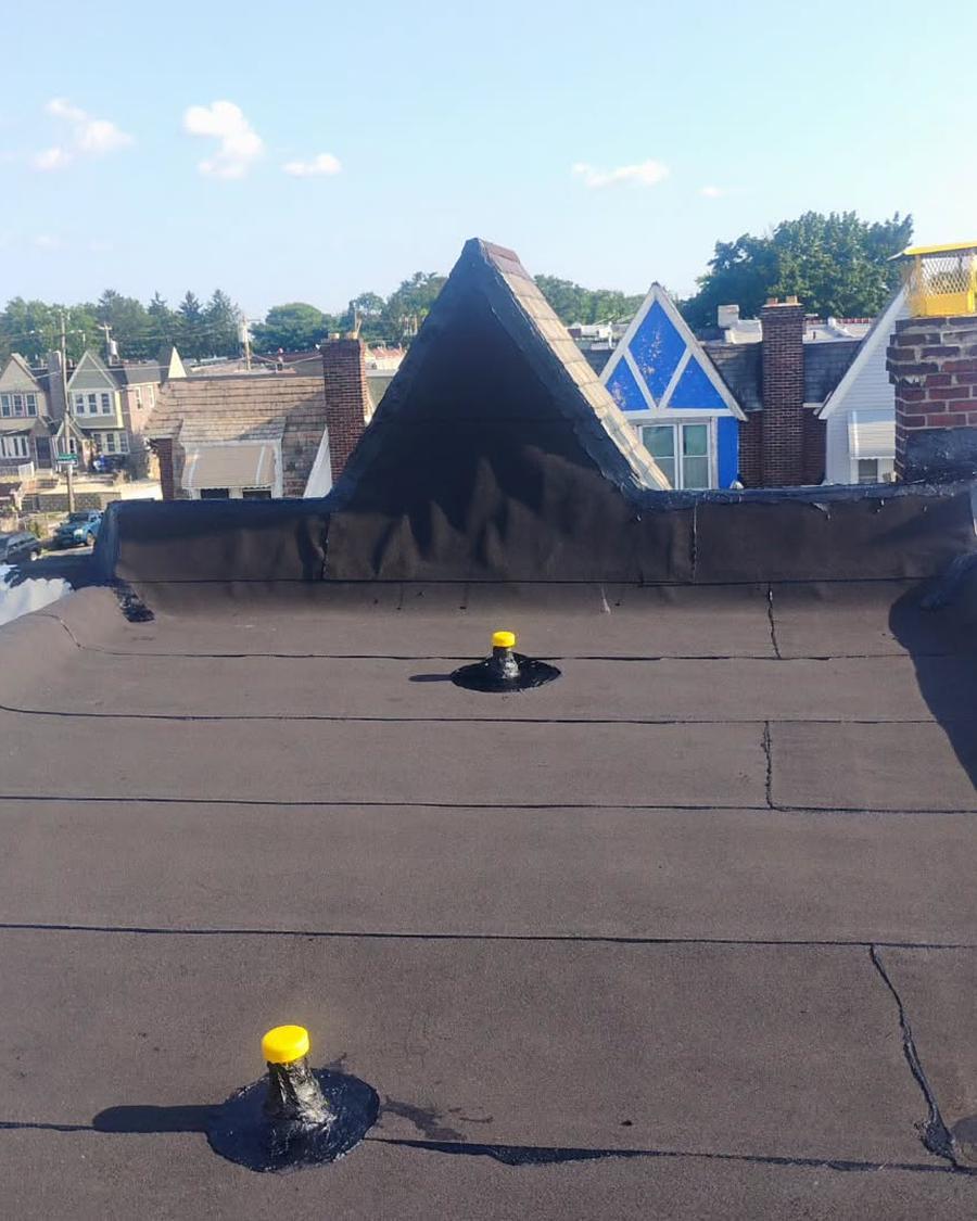 The same roof in new black membrane, cone dormer re-wrapped