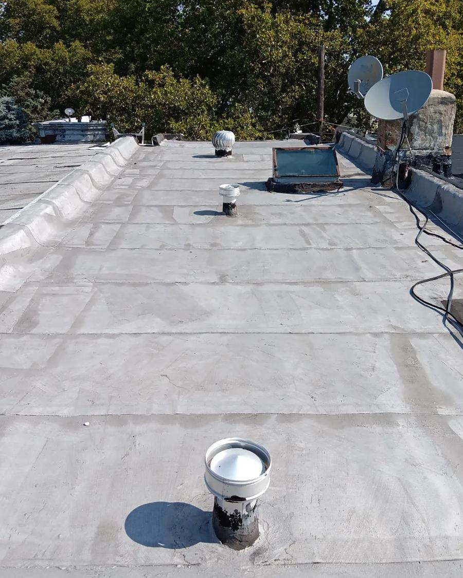 Chalky, weathered aluminium-coated roof before replacement