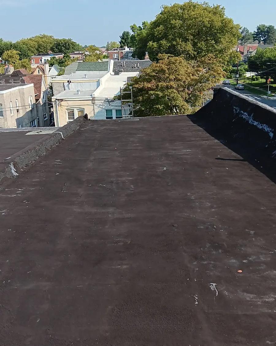 Bare, weather-beaten flat roof before MG Roofing coated it