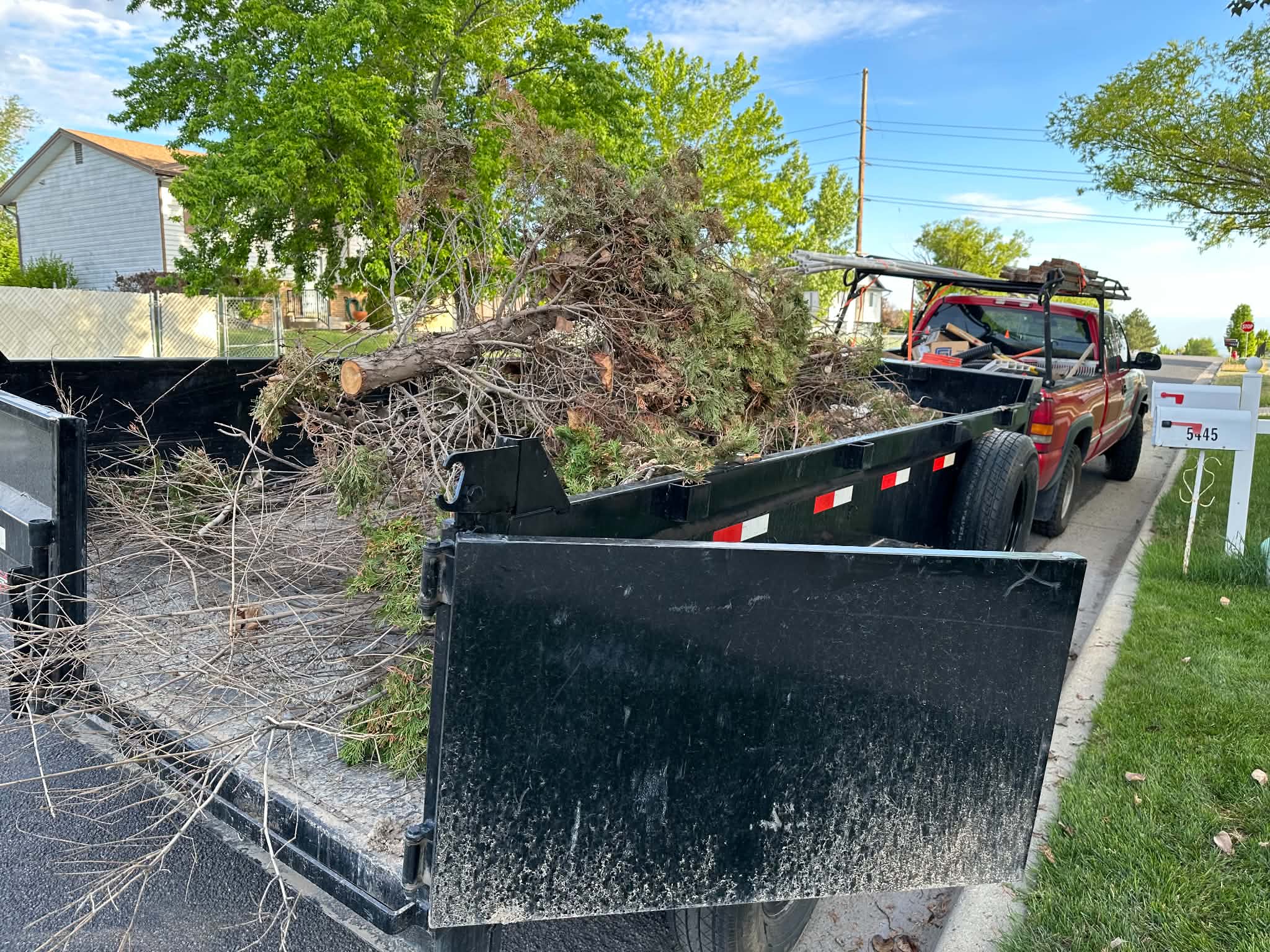 Truck loaded with tree branches and wood debris from a leaf clean-up