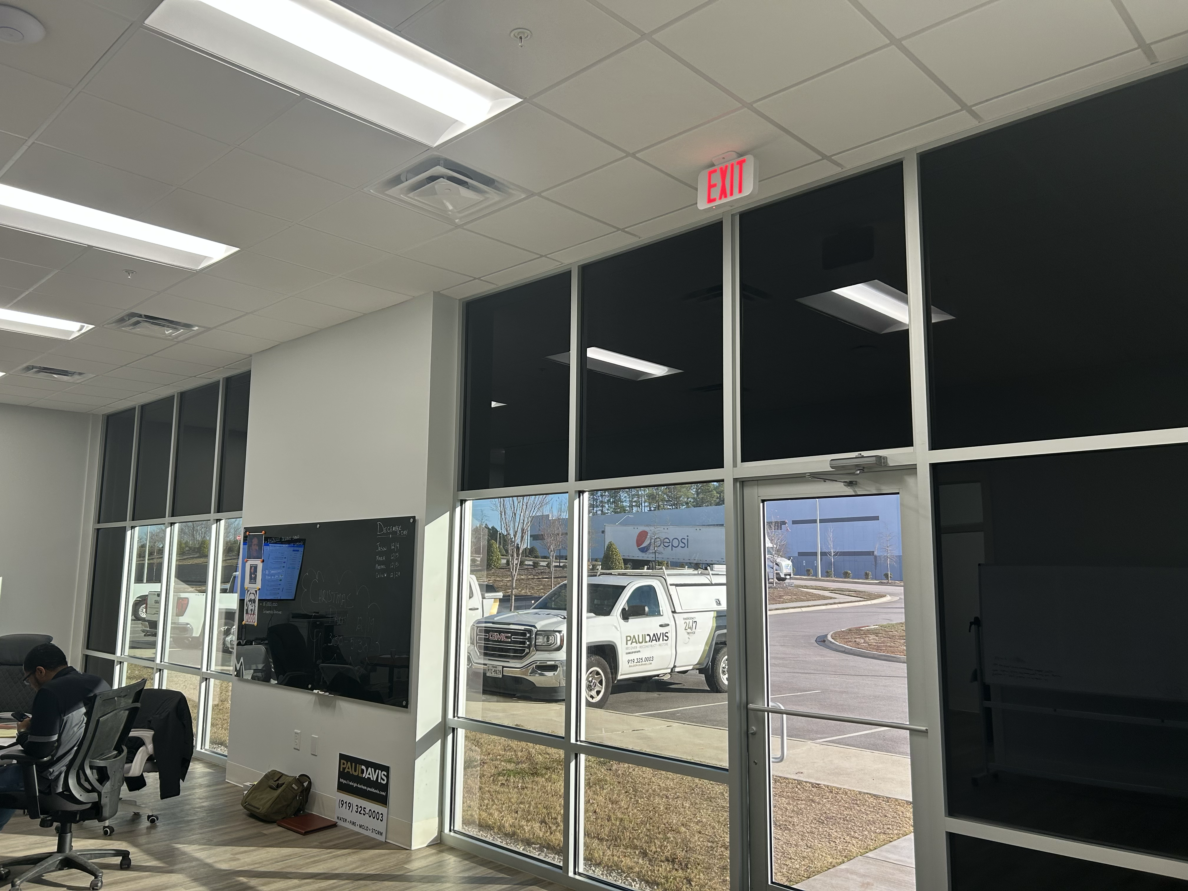 Open-plan office with tinted windows reducing glare for employees