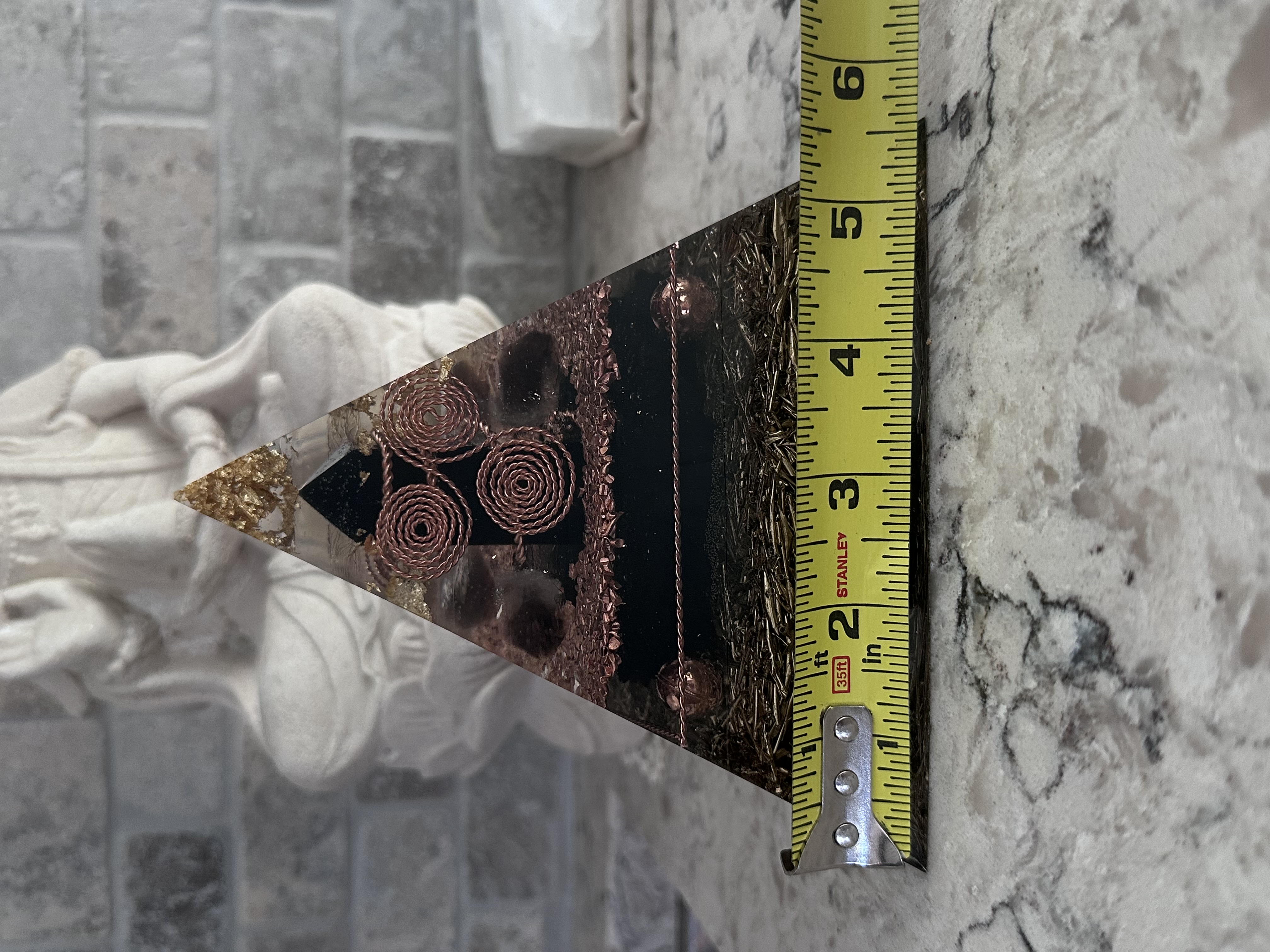 Large orgonite pyramid width measurement showing approximately 5.5 inch base