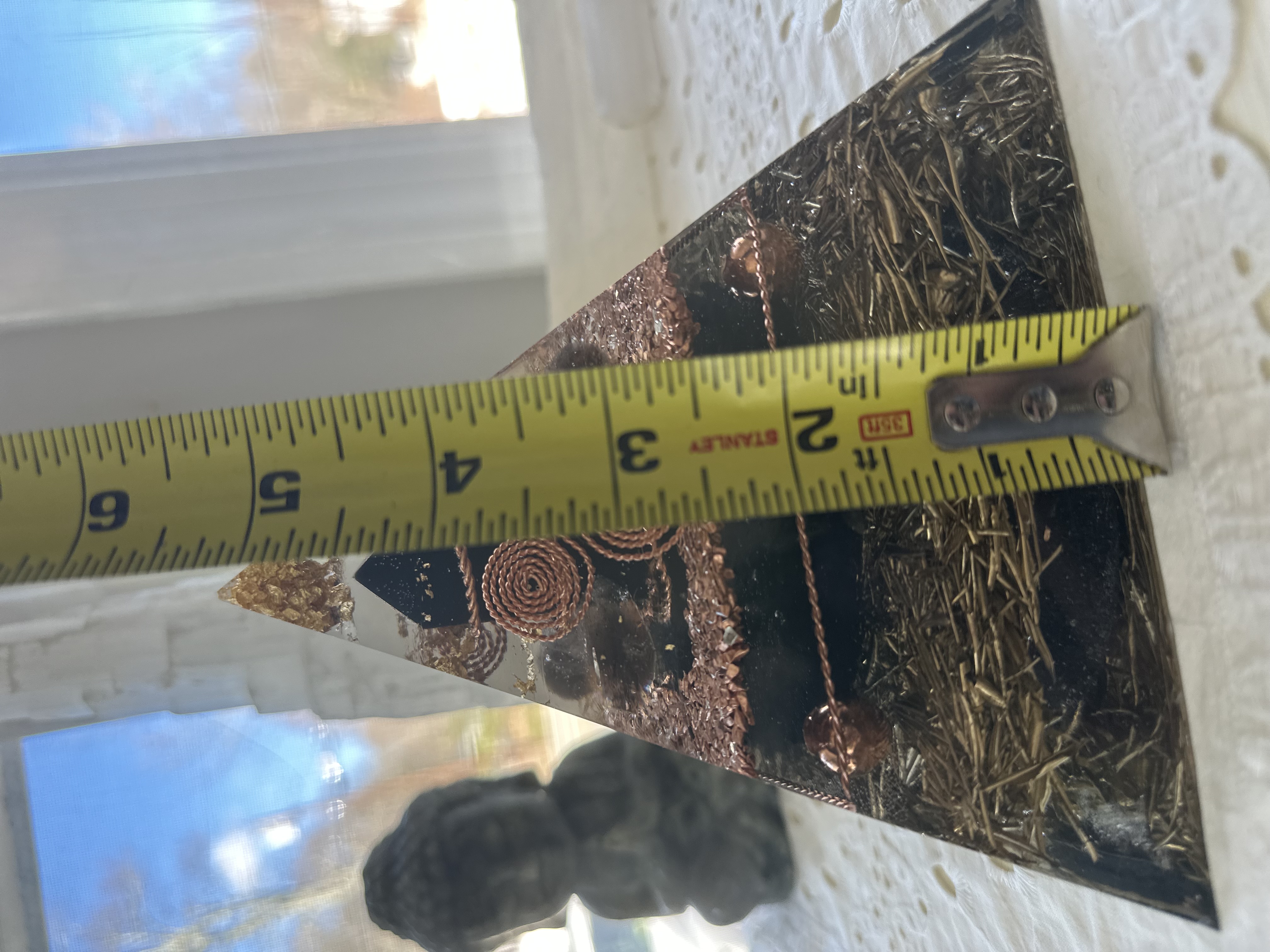 Large orgonite pyramid height measurement showing approximately 5.25 inches