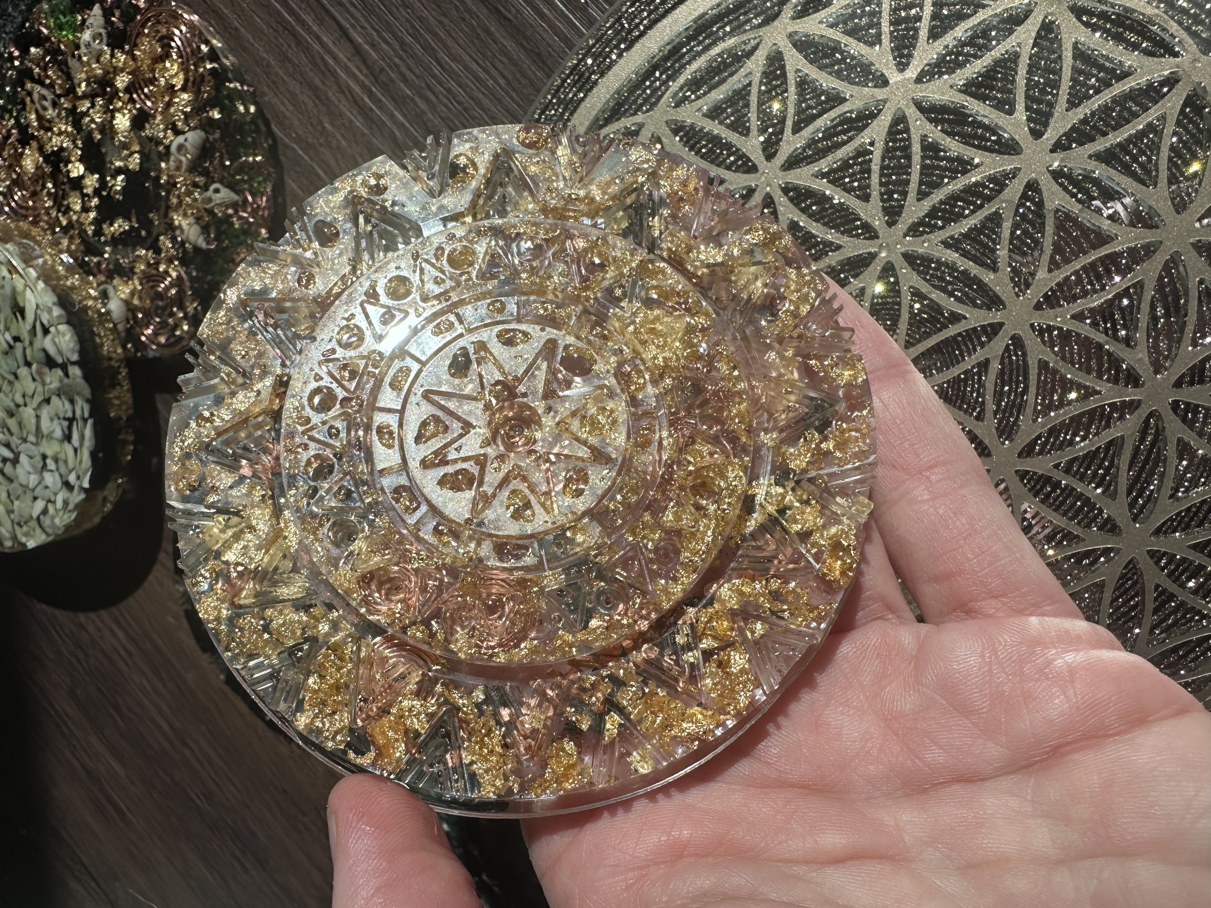 Golden sun mandala coaster in hand