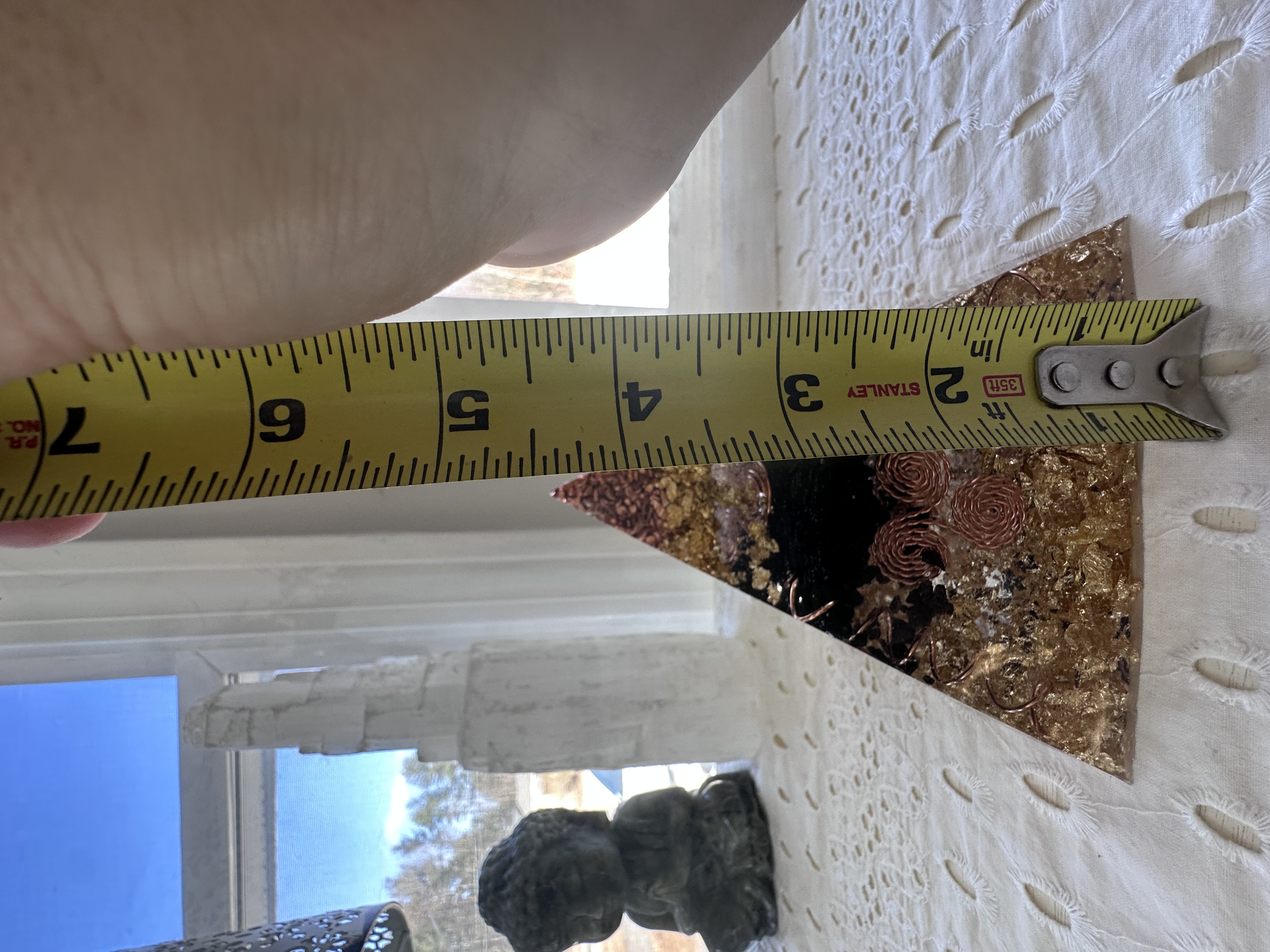 Small orgonite pyramid height measurement showing approximately 4.5 inches
