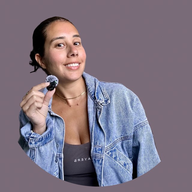Dr. Elaina Rosario smiling in a denim jacket