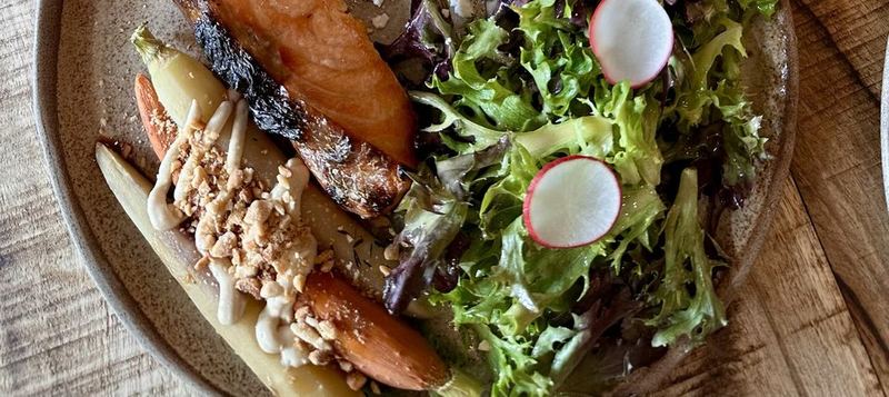 Roasted salmon, carrots with tahini, and a fresh green salad