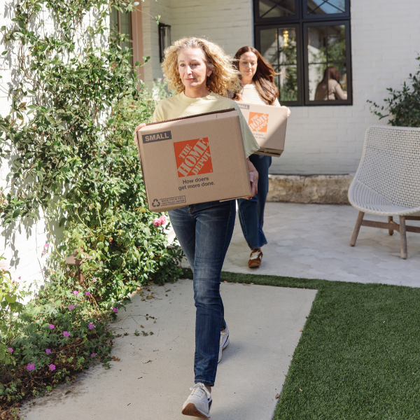 Open moving box with folded linens and packing tape
