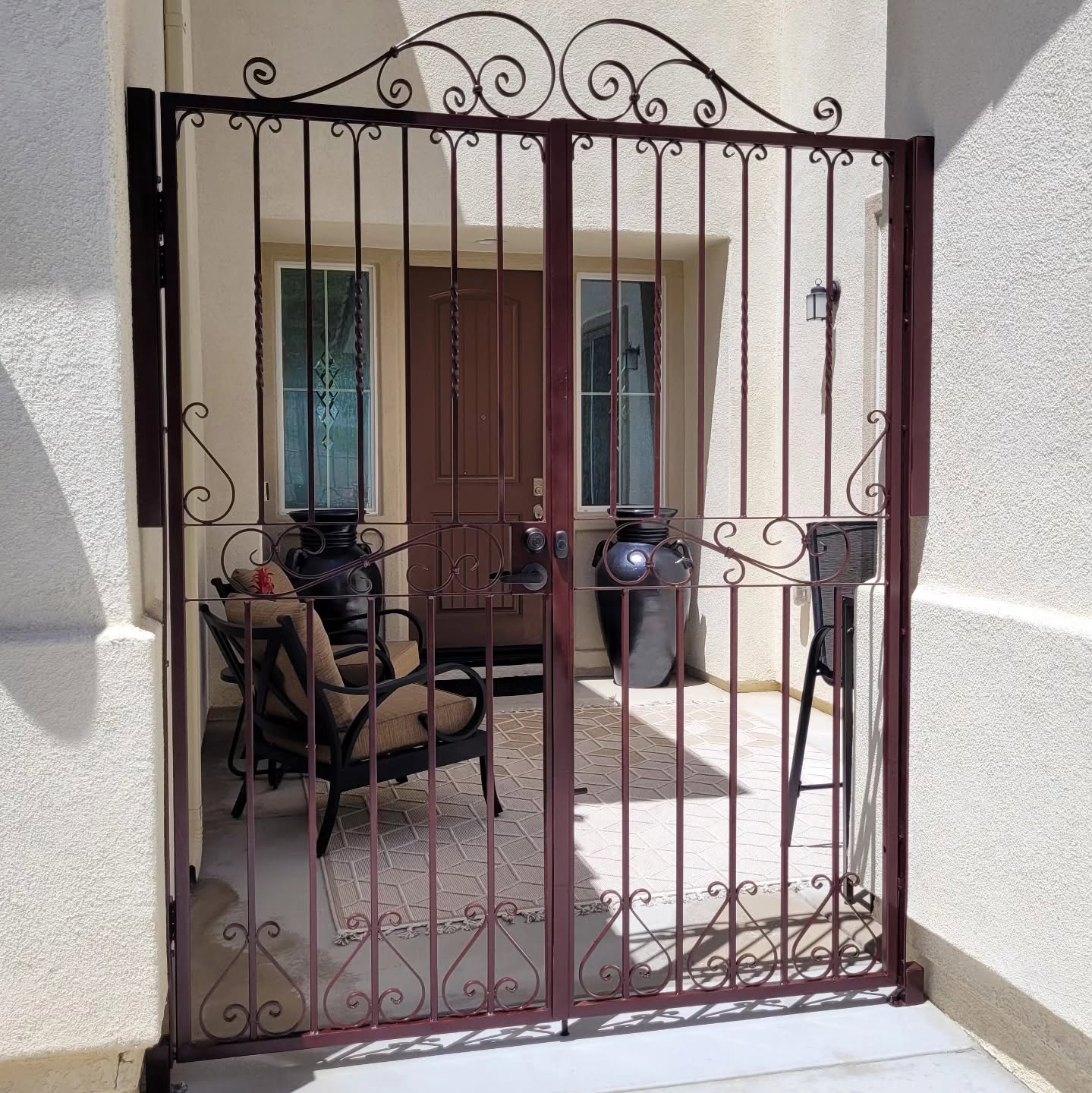 Custom ornamental wrought iron double entry gate by Gentry Ironworks