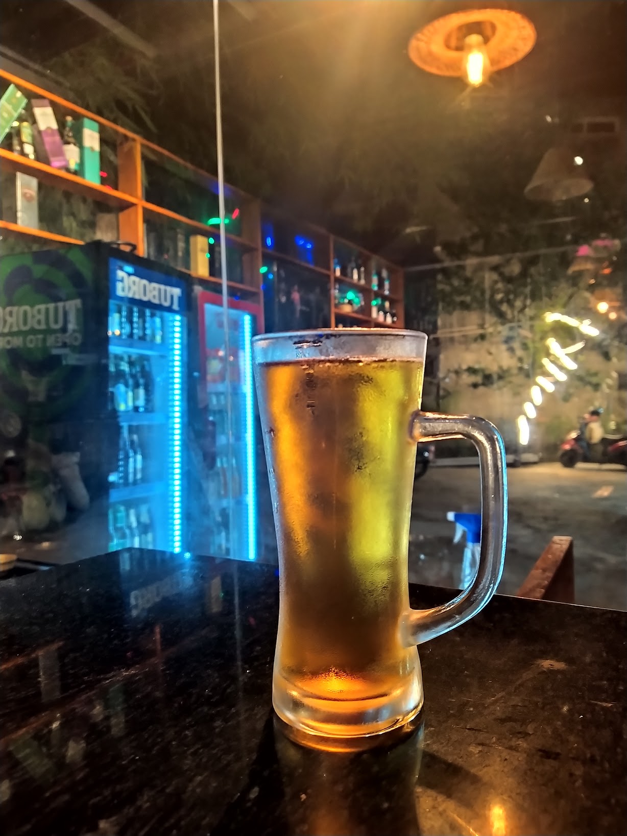 Chilled beer glass at Prachin Garden Restaurant night ambiance