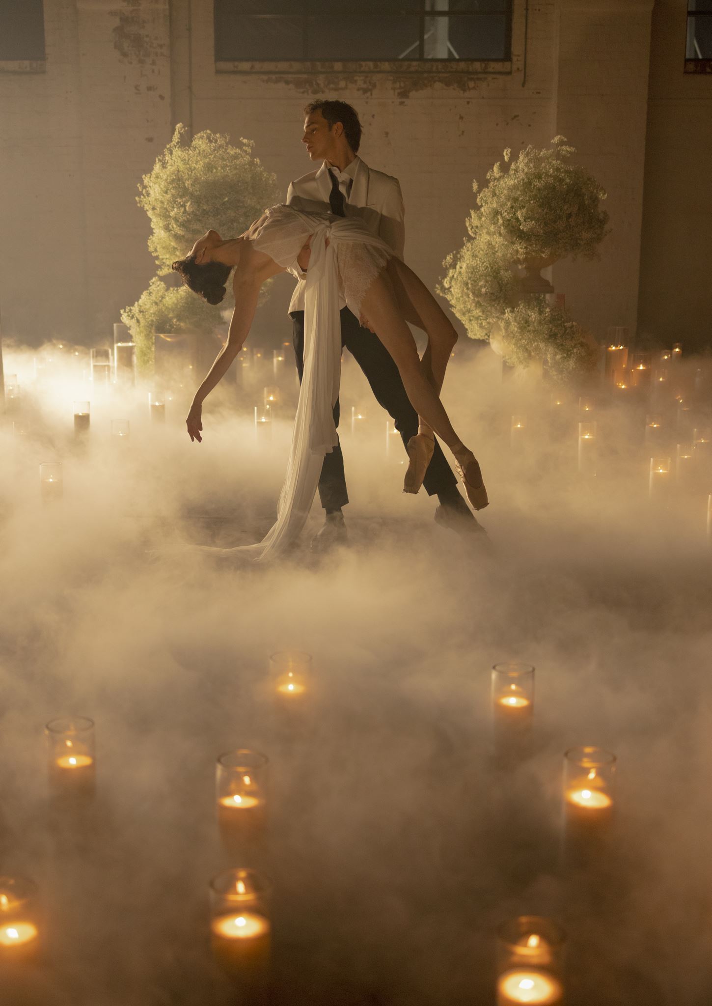 Sand candle field creating atmosphere for an editorial wedding installation.