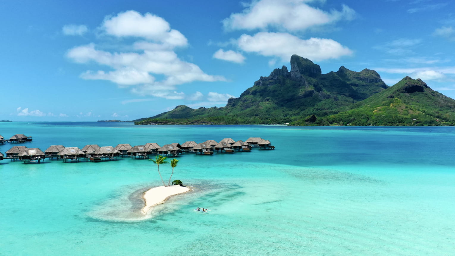 Four Seasons beach resort holiday with turquoise water and overwater villas