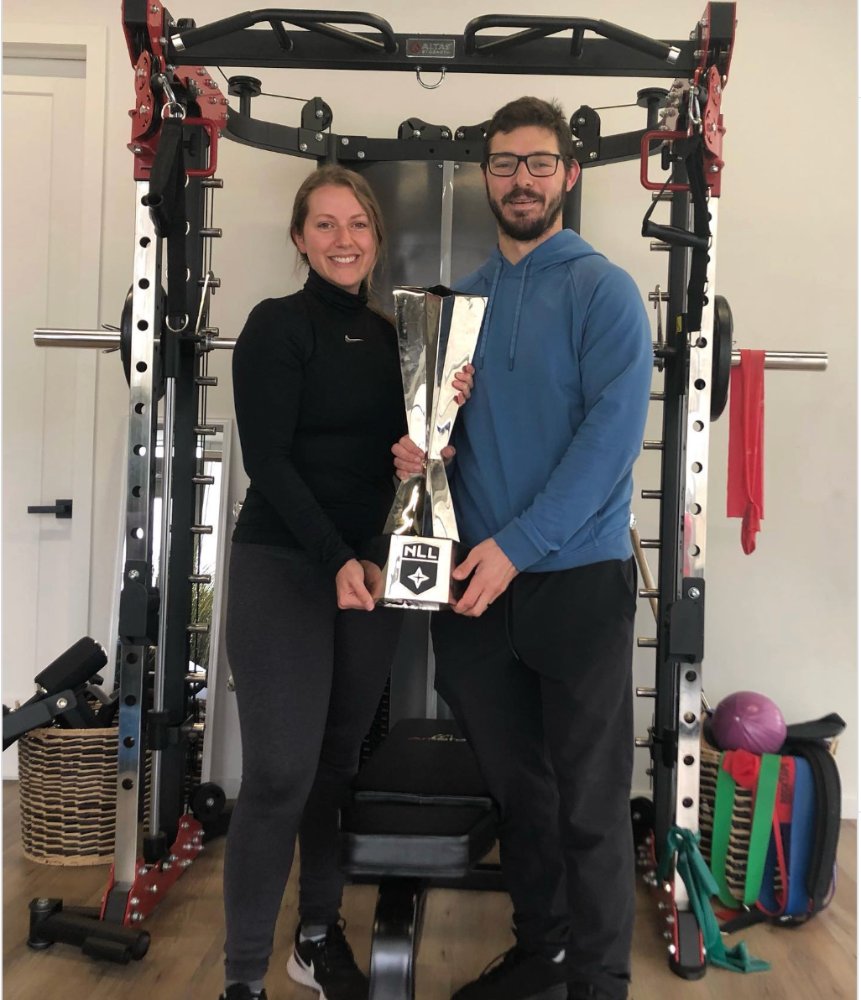 Victoria and Joey Cupido holding the National Lacrosse League championship trophy