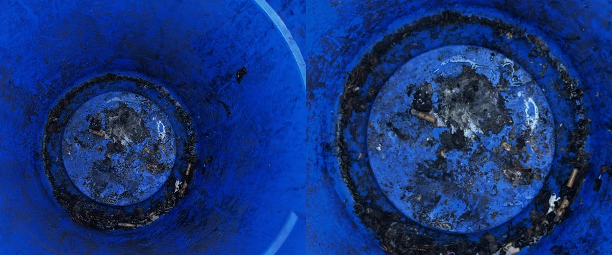 Inside view of a dirty blue plastic barrel with cigarette butts and debris at the bottom. Inside view of a dirty blue plastic barrel with cigarette butts and debris at the bottom.