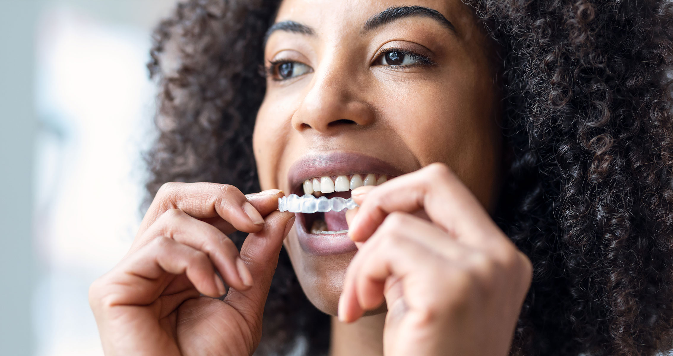 Patient holding an invisalign aligner