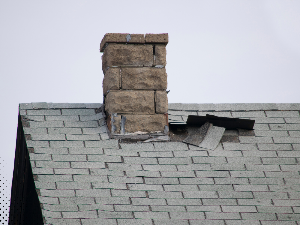Damaged shingles around a chimney.