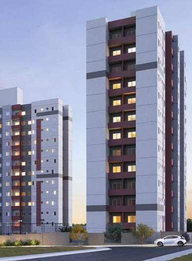 a tall building with lots of windows against a blue sky