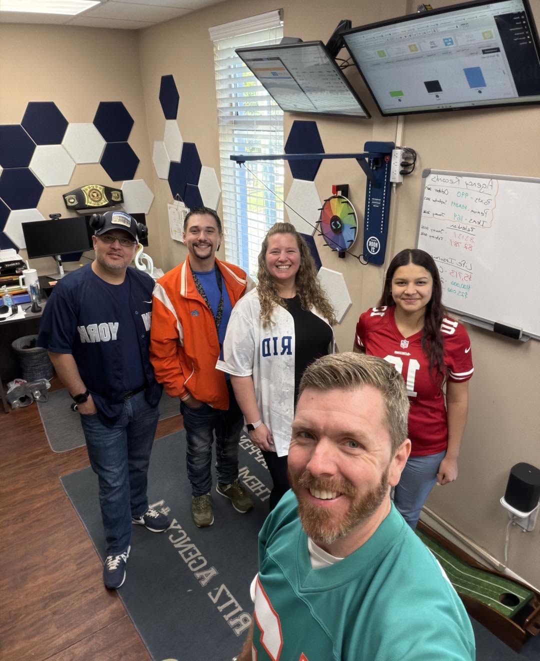 The Ritz Agency team in sports jerseys in the Ocala office