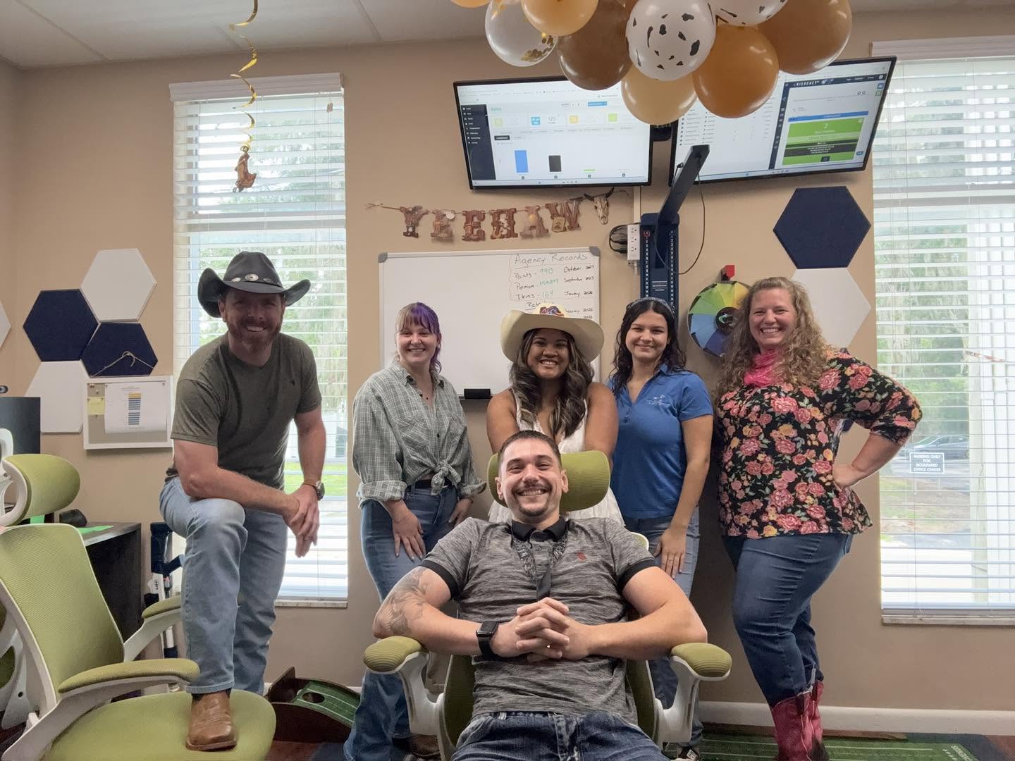The Ritz Agency team in western wear for a theme day at the Ocala office