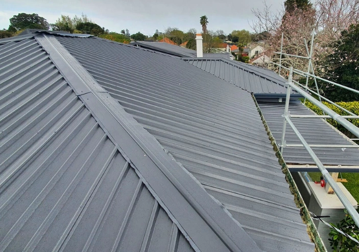 Installation of new long-run iron roofing on Auckland home by Phoenix Roofing