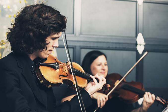 Violinist practicing thoughtfully