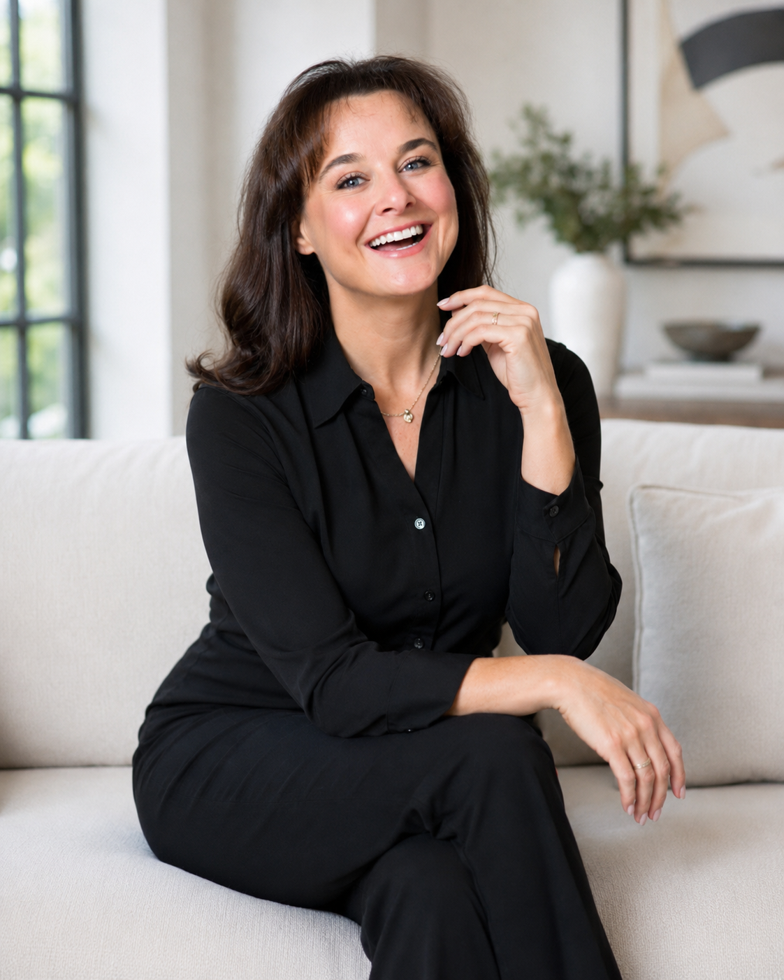 Ashley Cloud laughing on a white couch