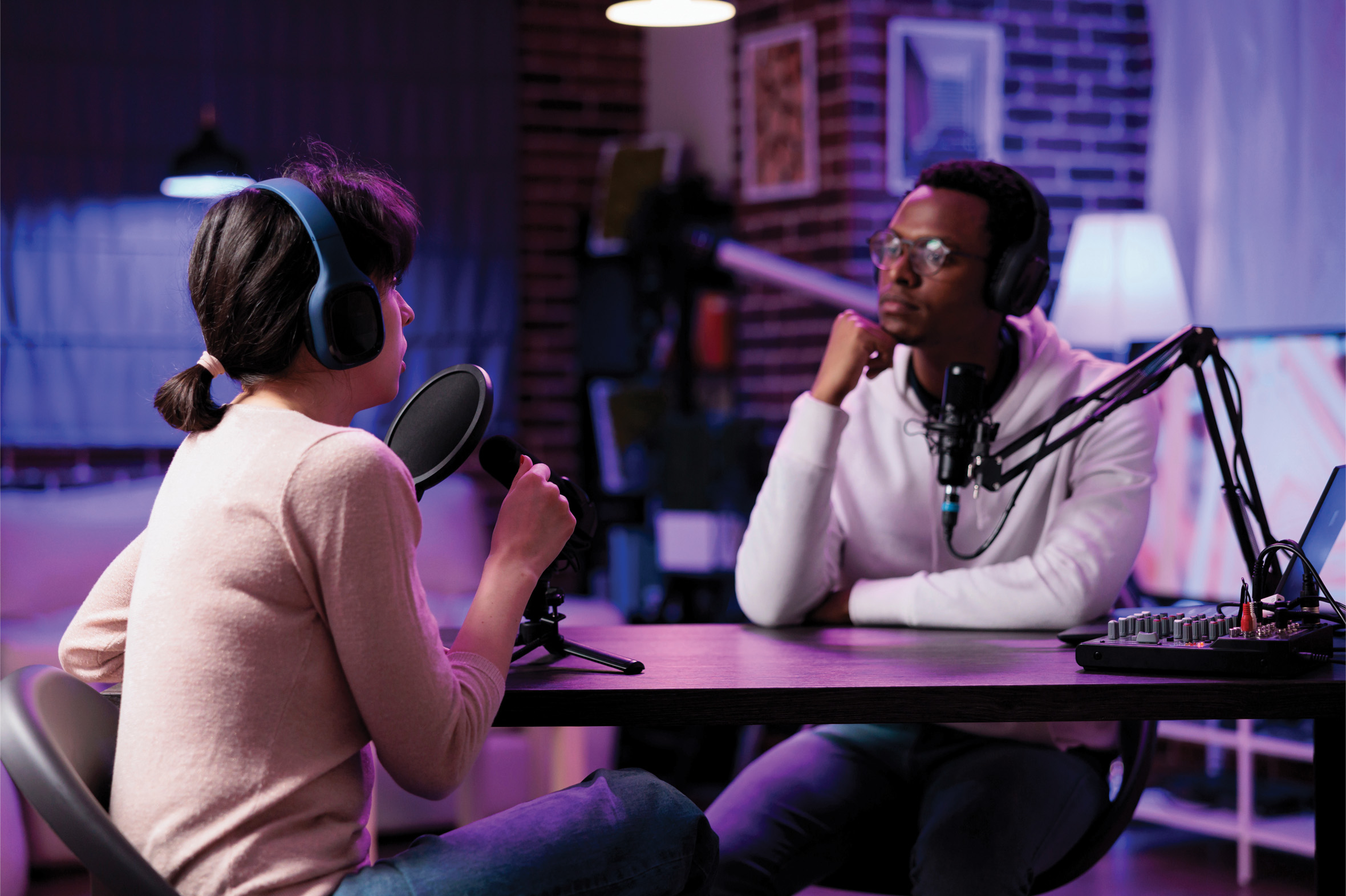 Host and guest recording a podcast interview together